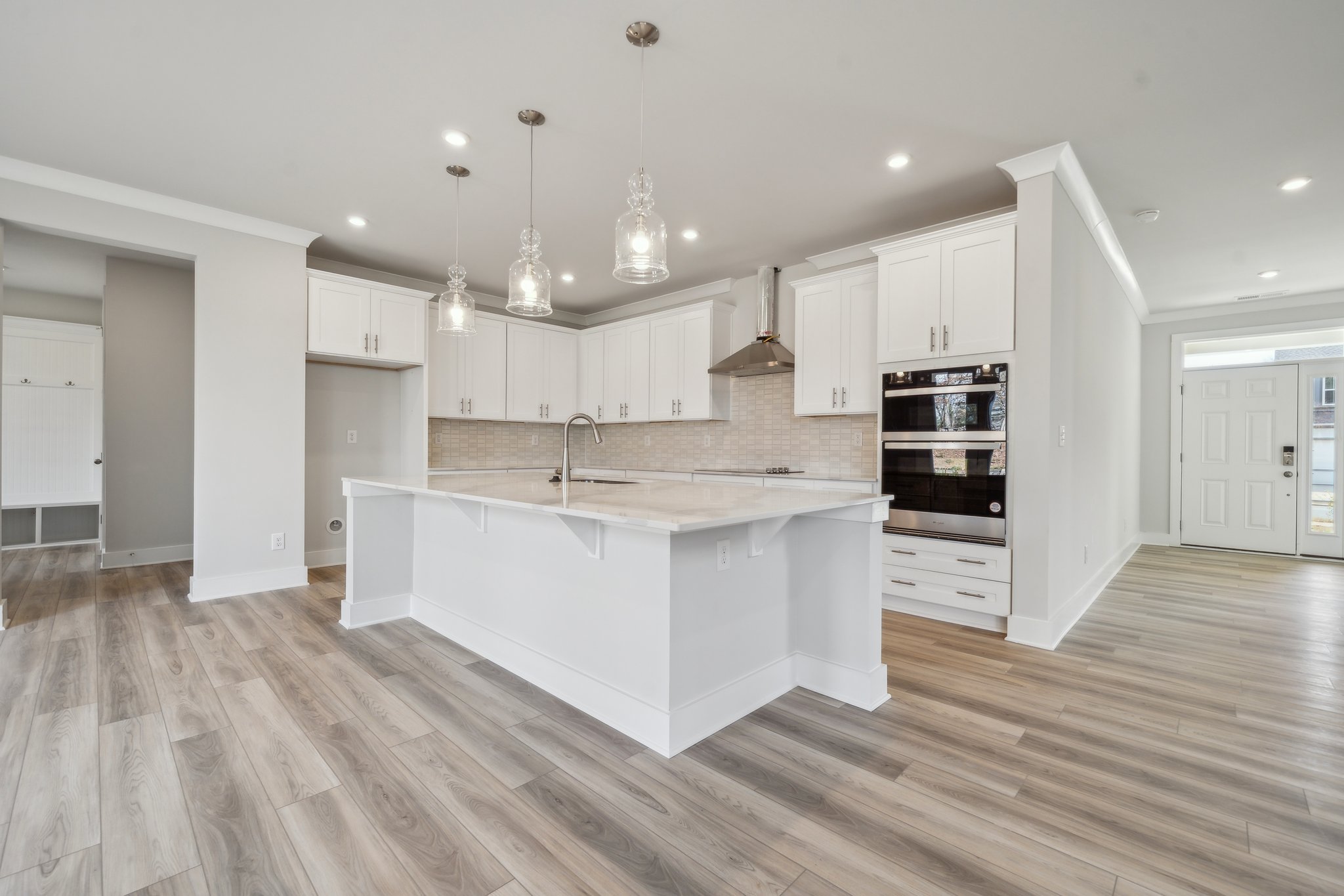 A kitchen with white cabinets.