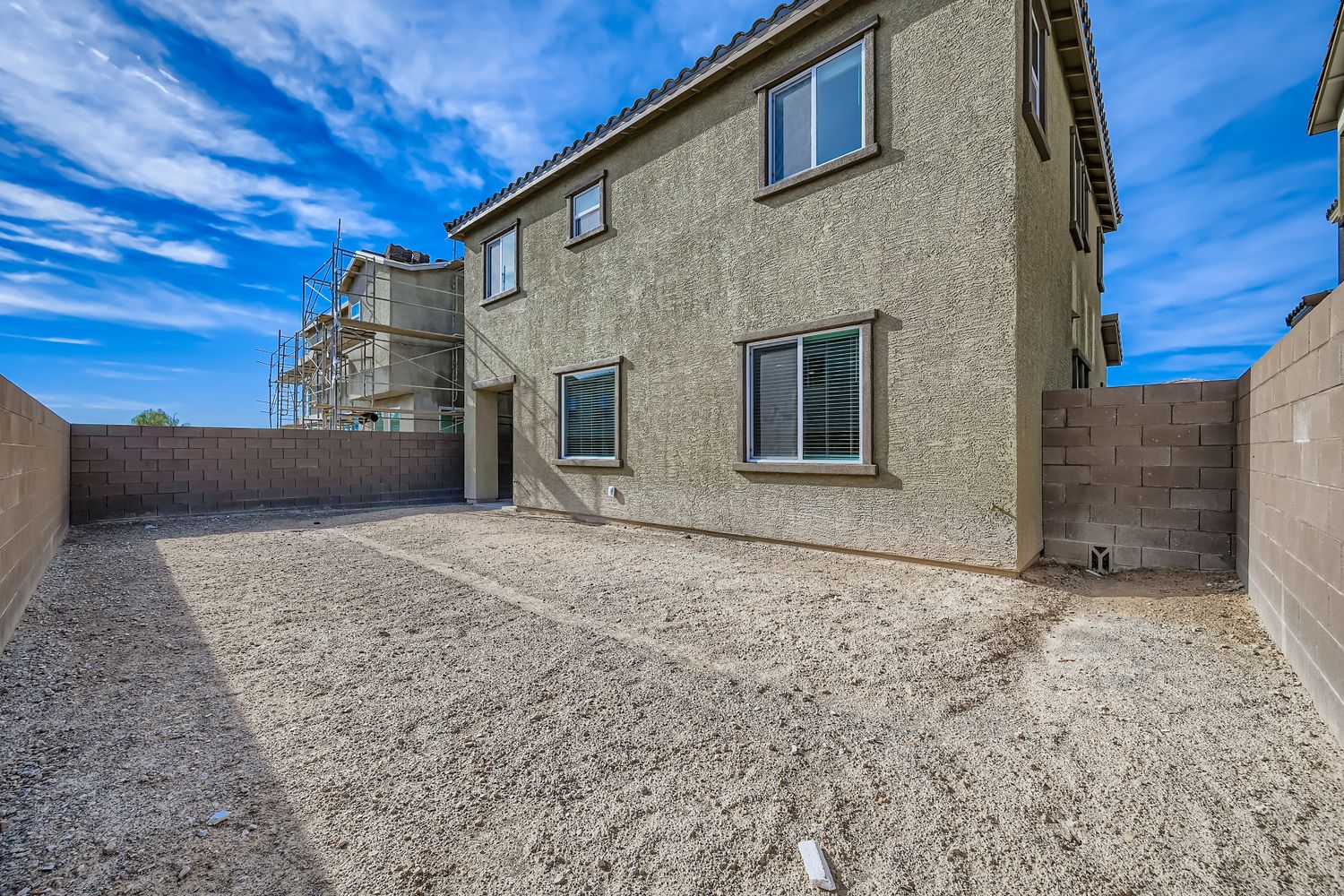 A building with a dirt lot.