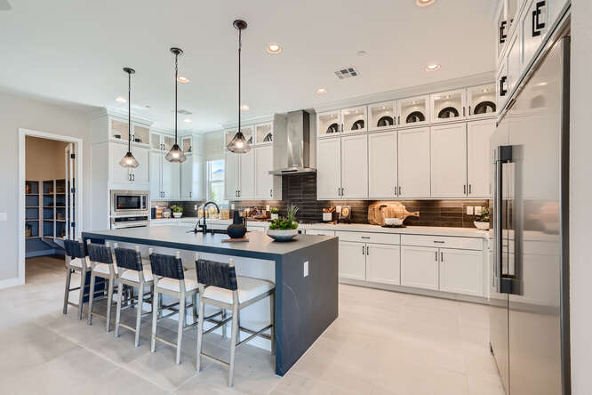 A kitchen with white cabinets.