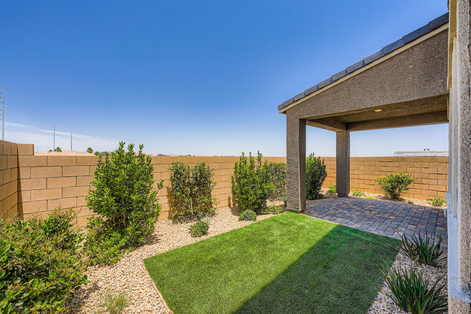 A backyard with a brick building.