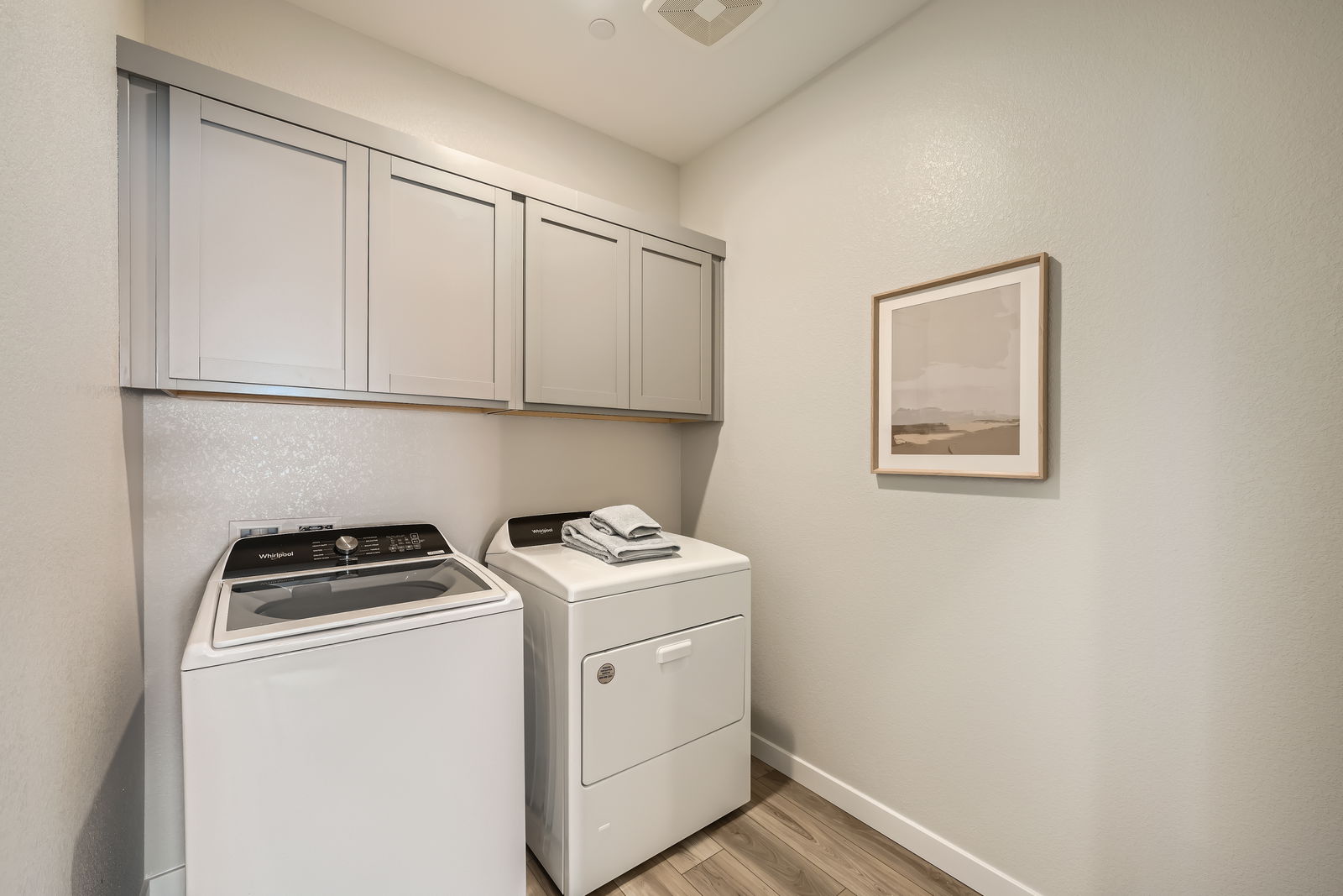 A kitchen with white cabinets.