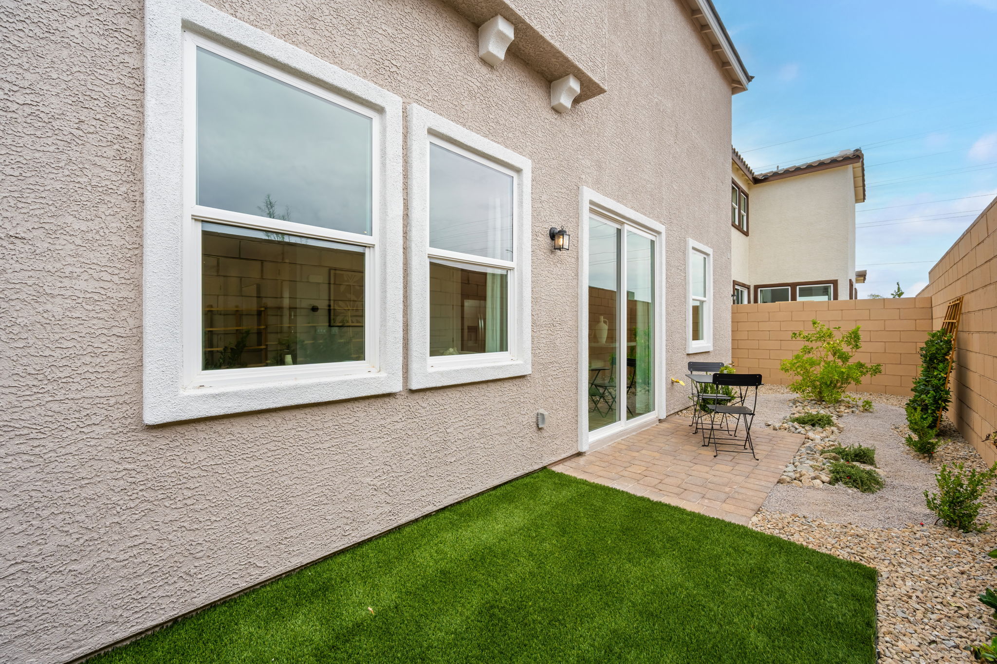 A house with a lawn and a chair in the front.