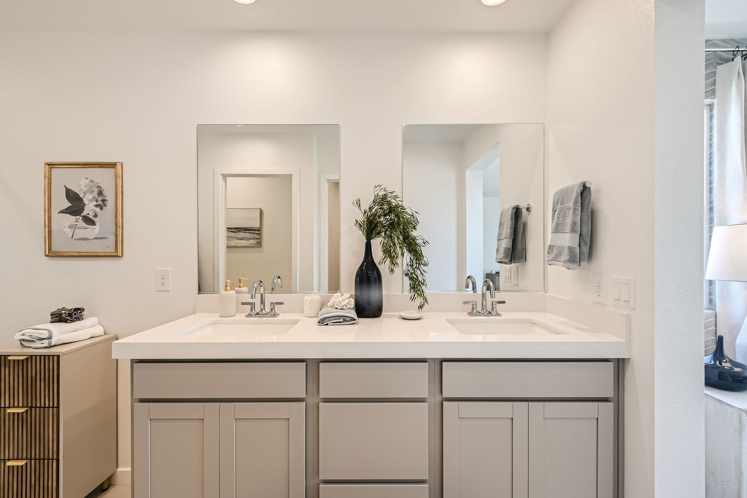 A bathroom with a sink and a mirror.