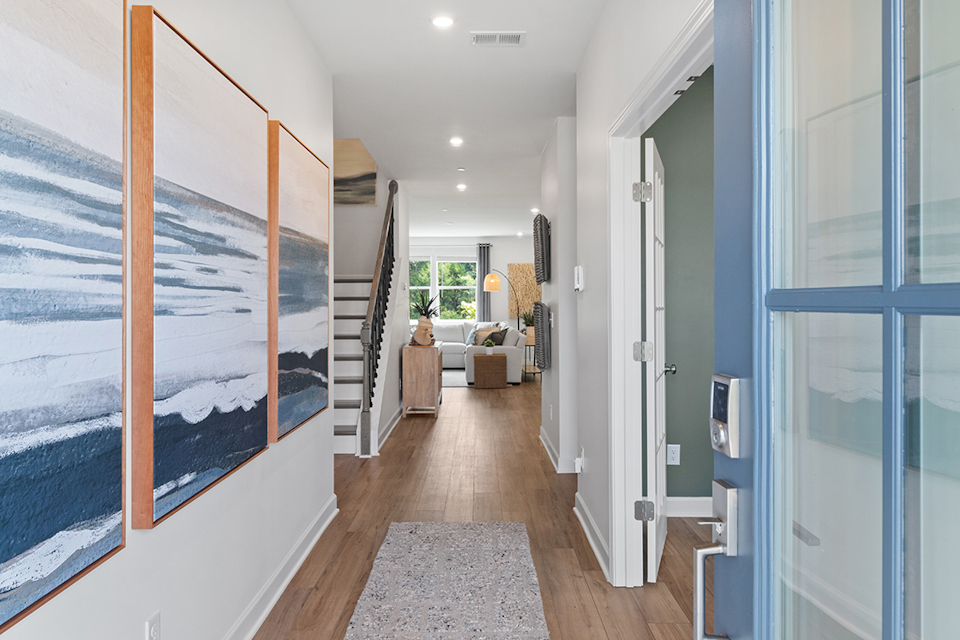 A hallway with a wall of paintings.