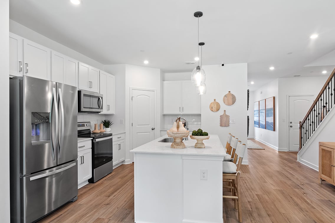 A kitchen with white cabinets.
