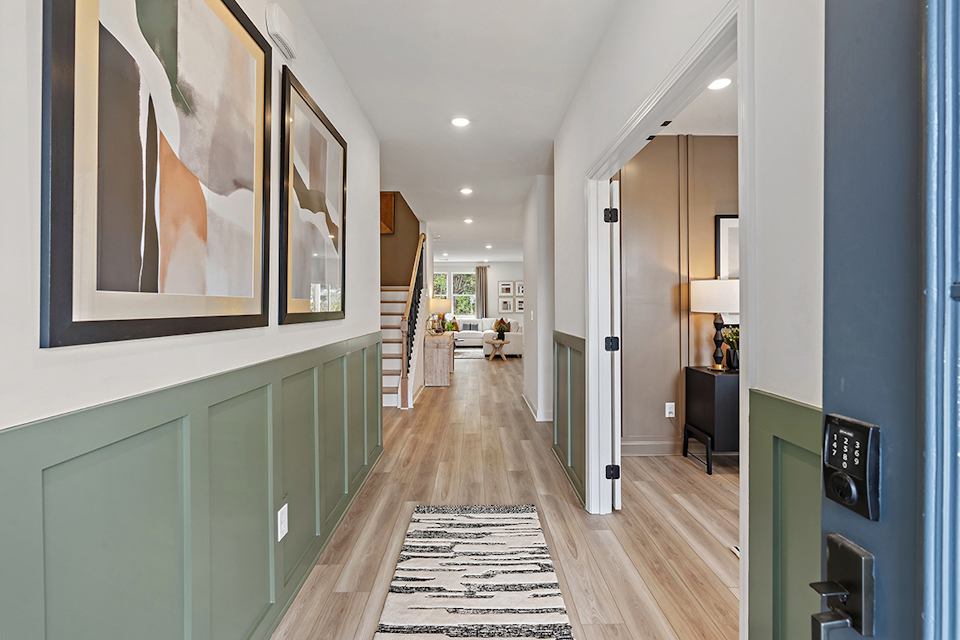 A long hallway with a wood floor.