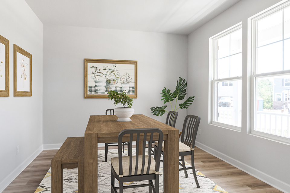 A dining room table with chairs and a plant on it.