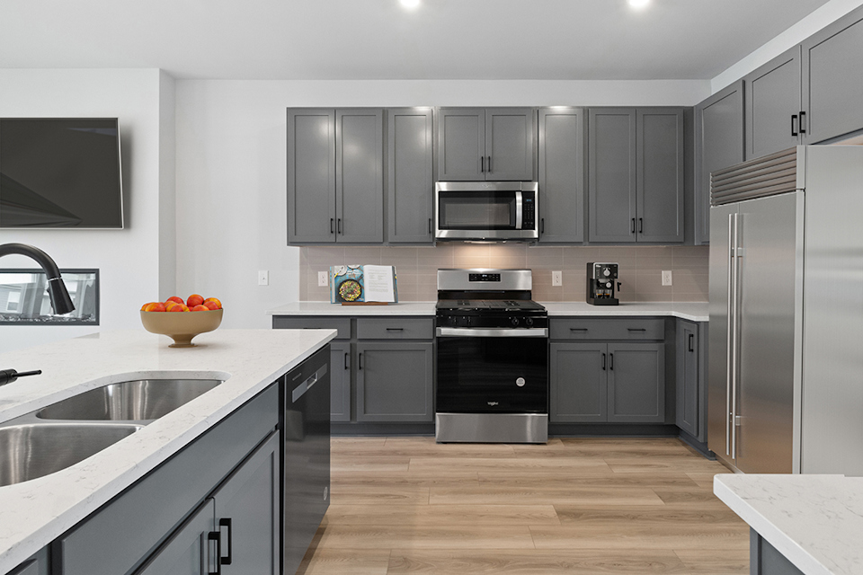 A kitchen with black cabinets.