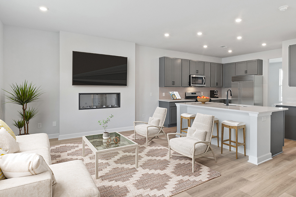 A kitchen with a tv and chairs.