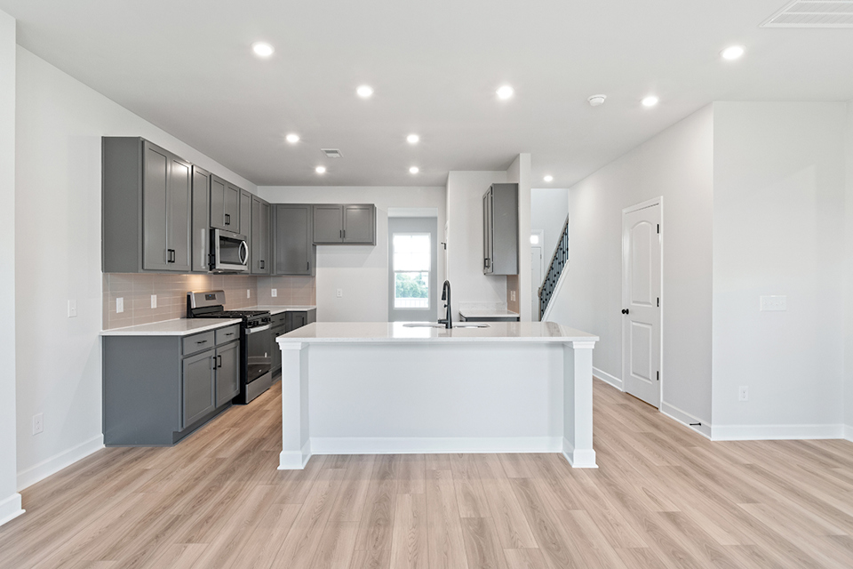 A kitchen with white cabinets.