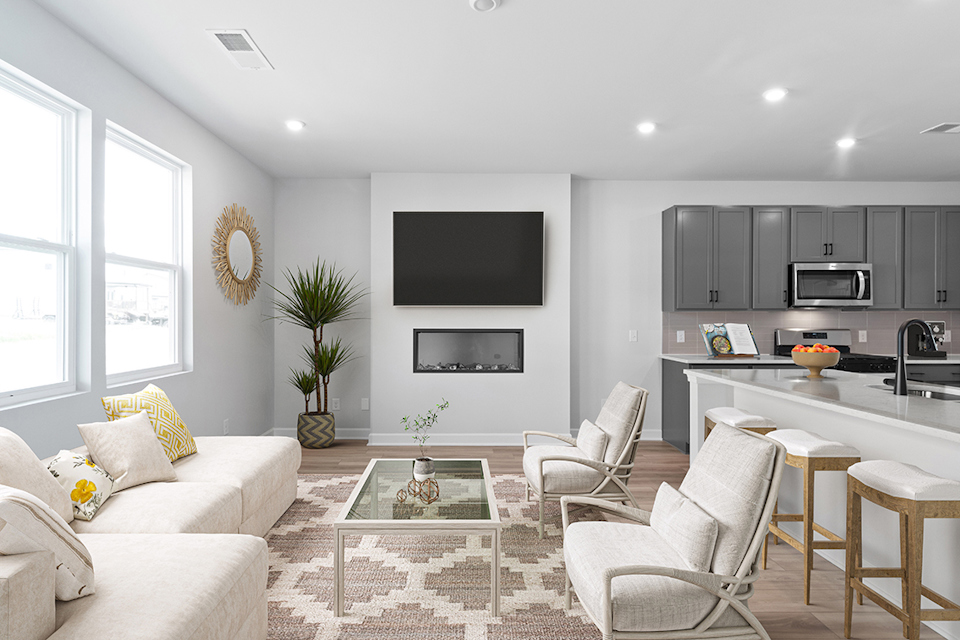 A living room with a tv and chairs.