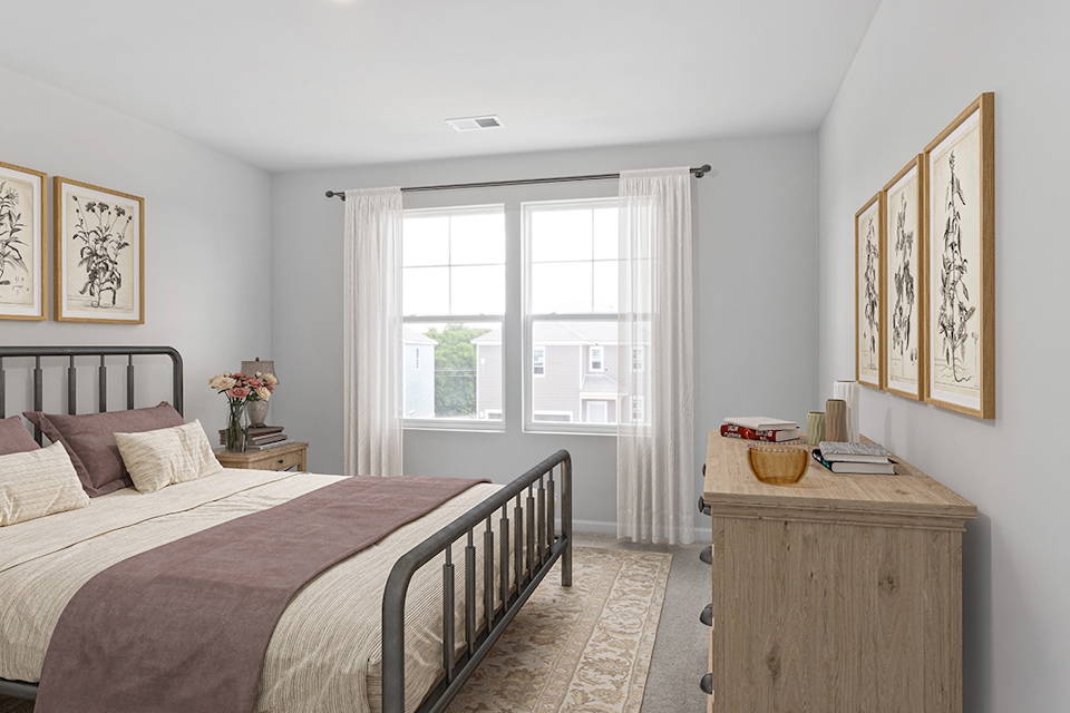 A bedroom with a bed and a window.