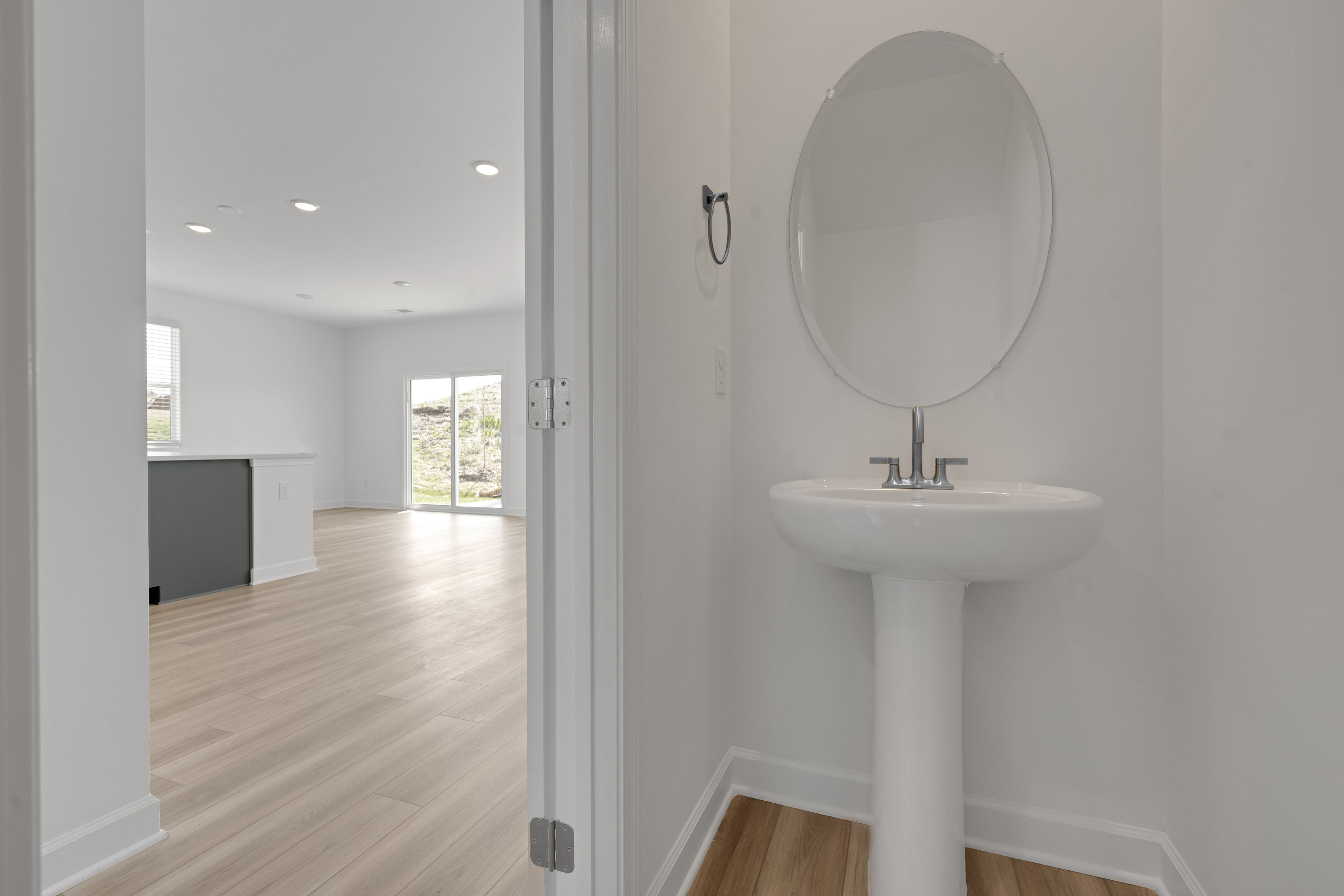 A bathroom with a large mirror.