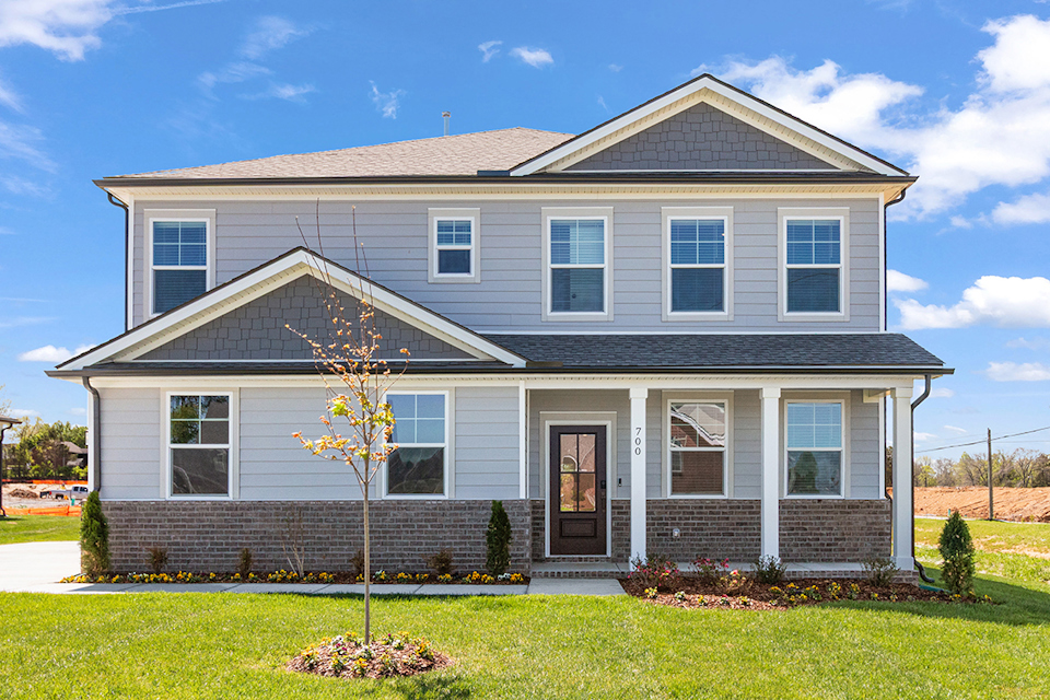 A house with a tree in the front.