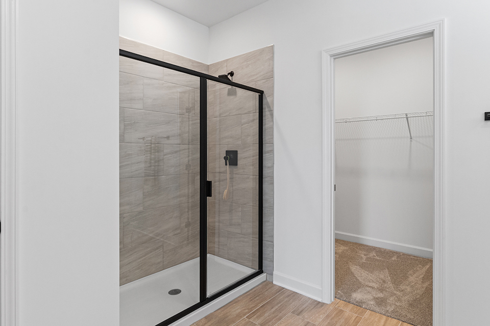 A room with a glass door and a glass shower.