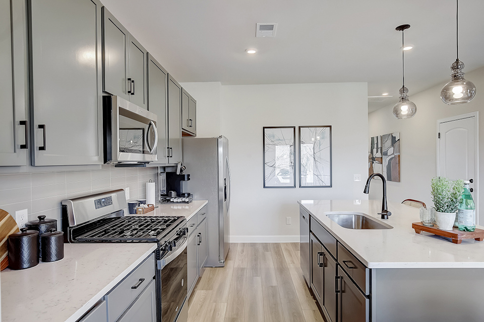 A kitchen with white cabinets.