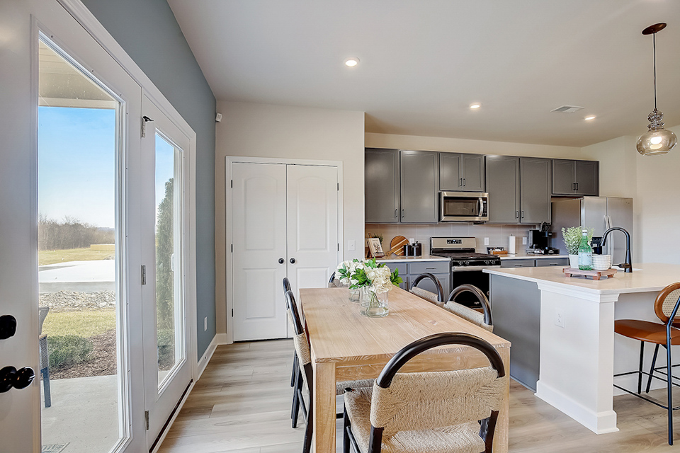 A kitchen with a dining table.