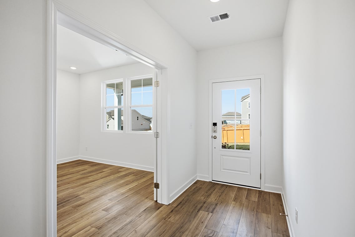 A room with a wood floor and white walls.