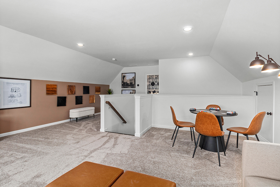 A room with a table chairs and a couch.