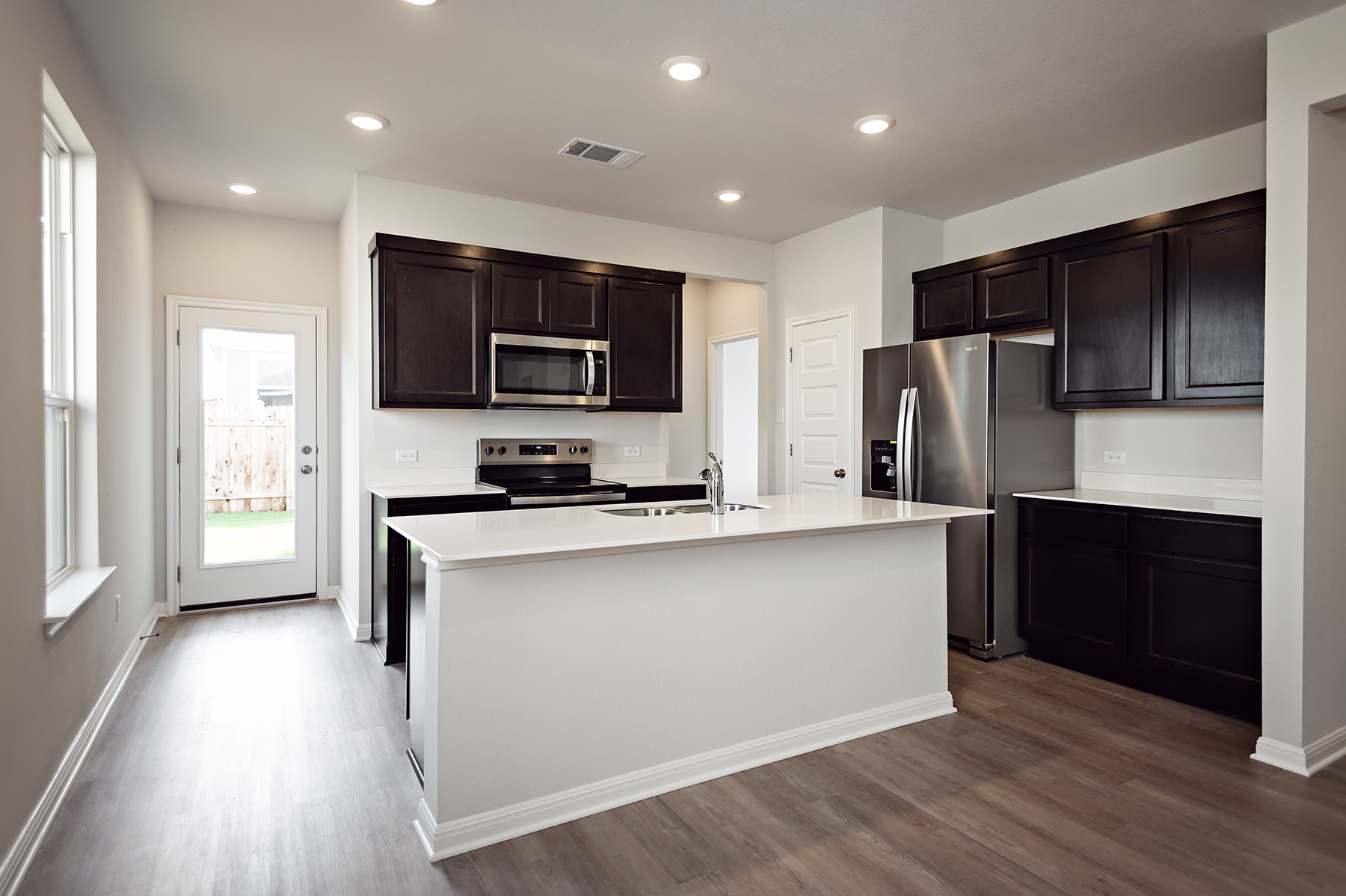 A kitchen with black cabinets.