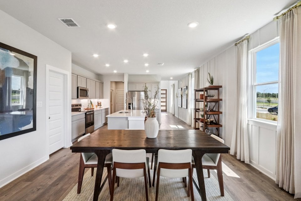 A dining room table with chairs.