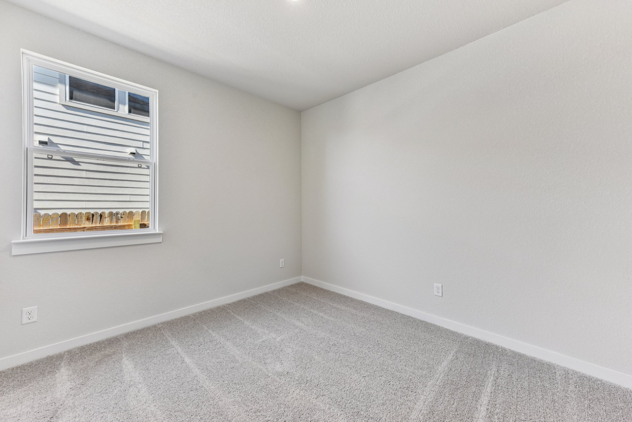 A room with a window and a vent.