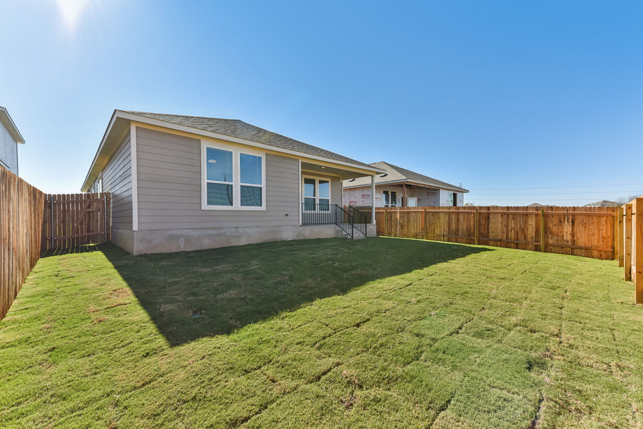 A house with a fence and grass.
