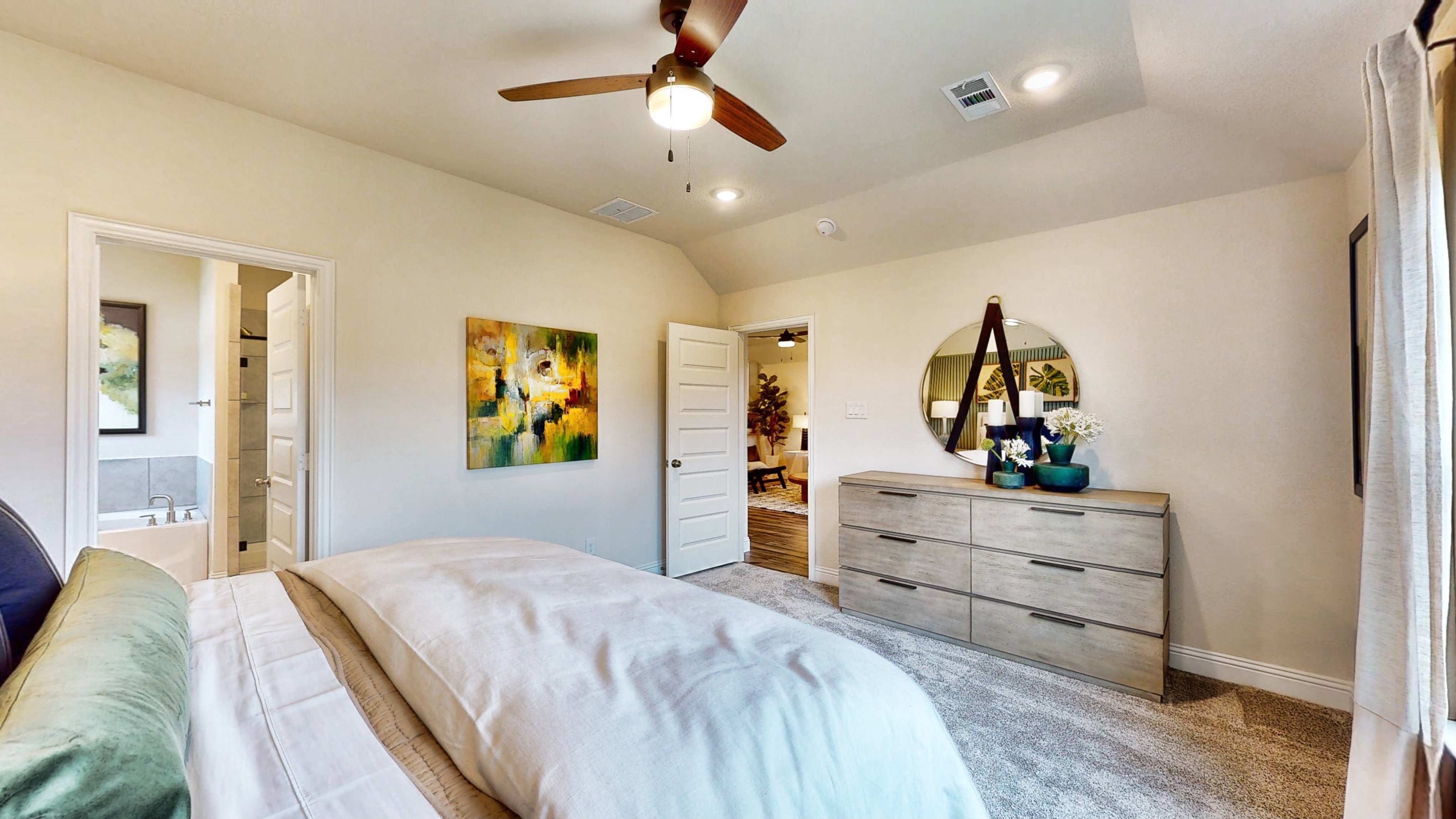 A bedroom with a bed and a dresser.