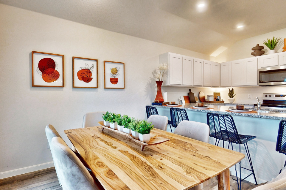 A kitchen with a dining table.