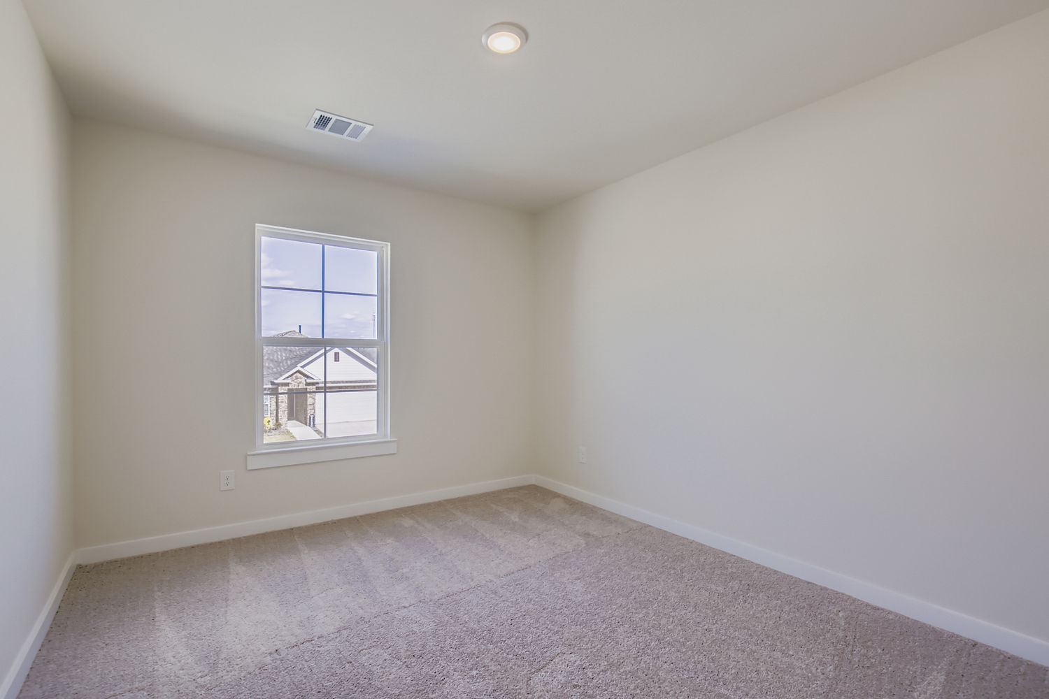 A room with a window and a carpet.