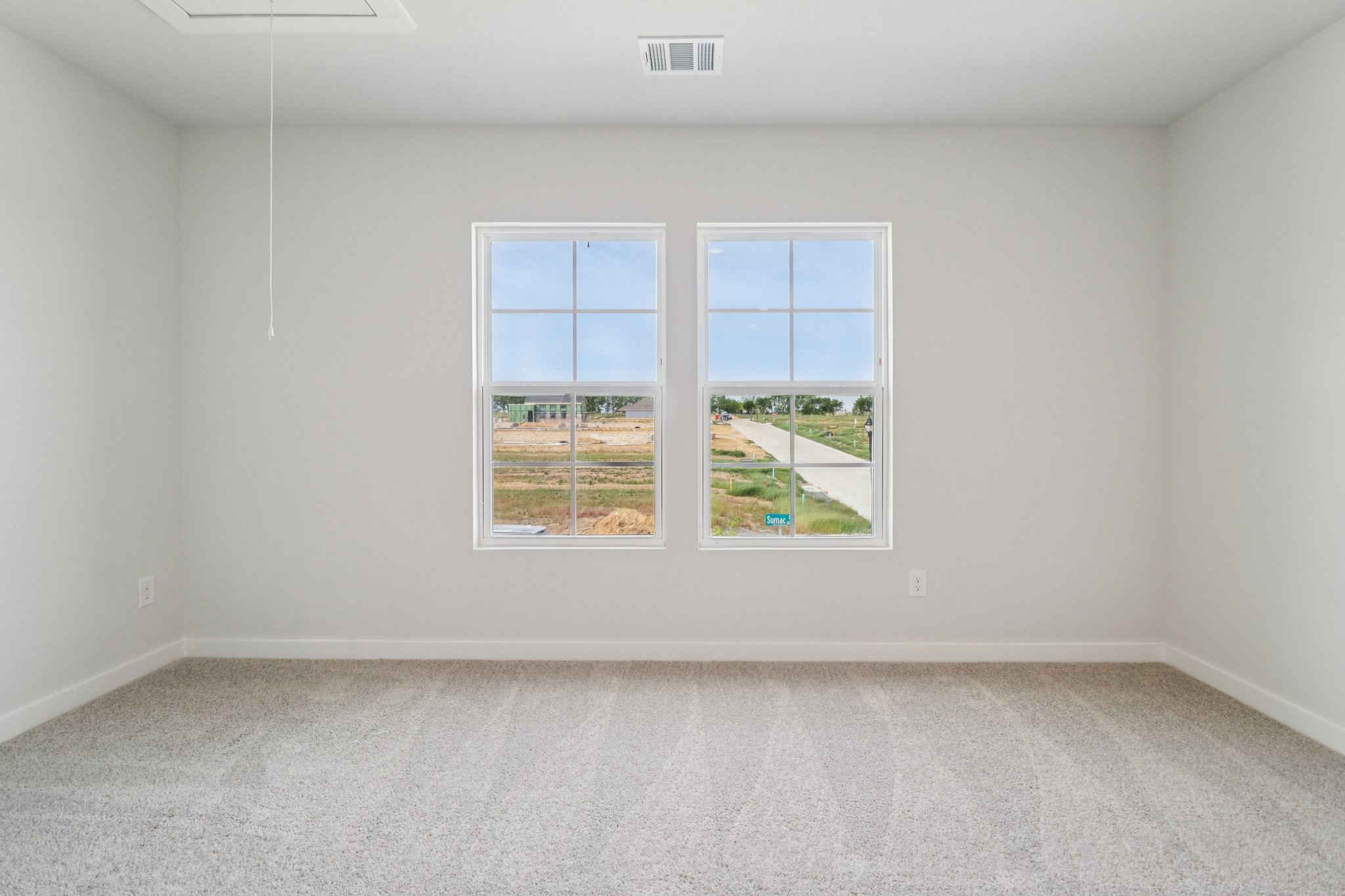 A room with a window and a carpet.