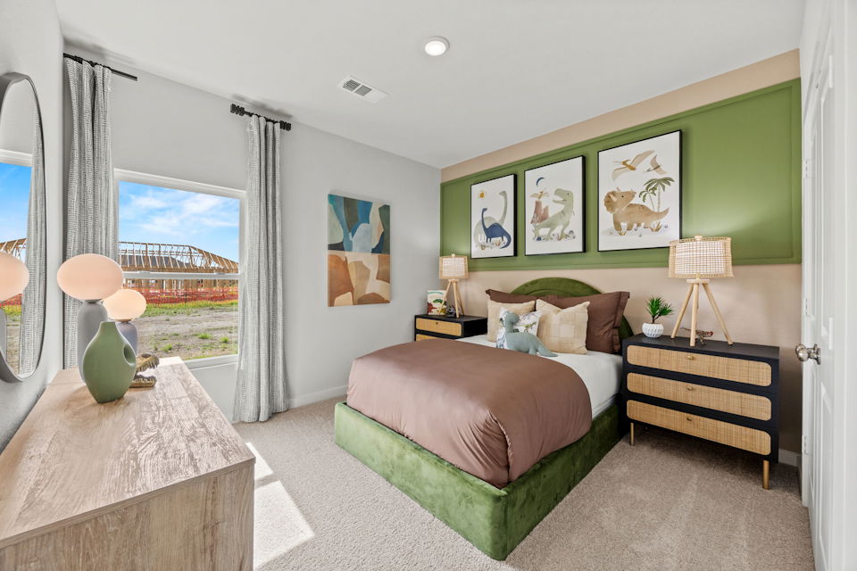 A bedroom with a large window.