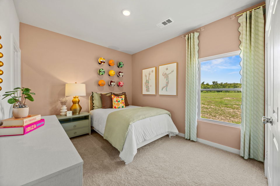 A bedroom with a bed and a window.