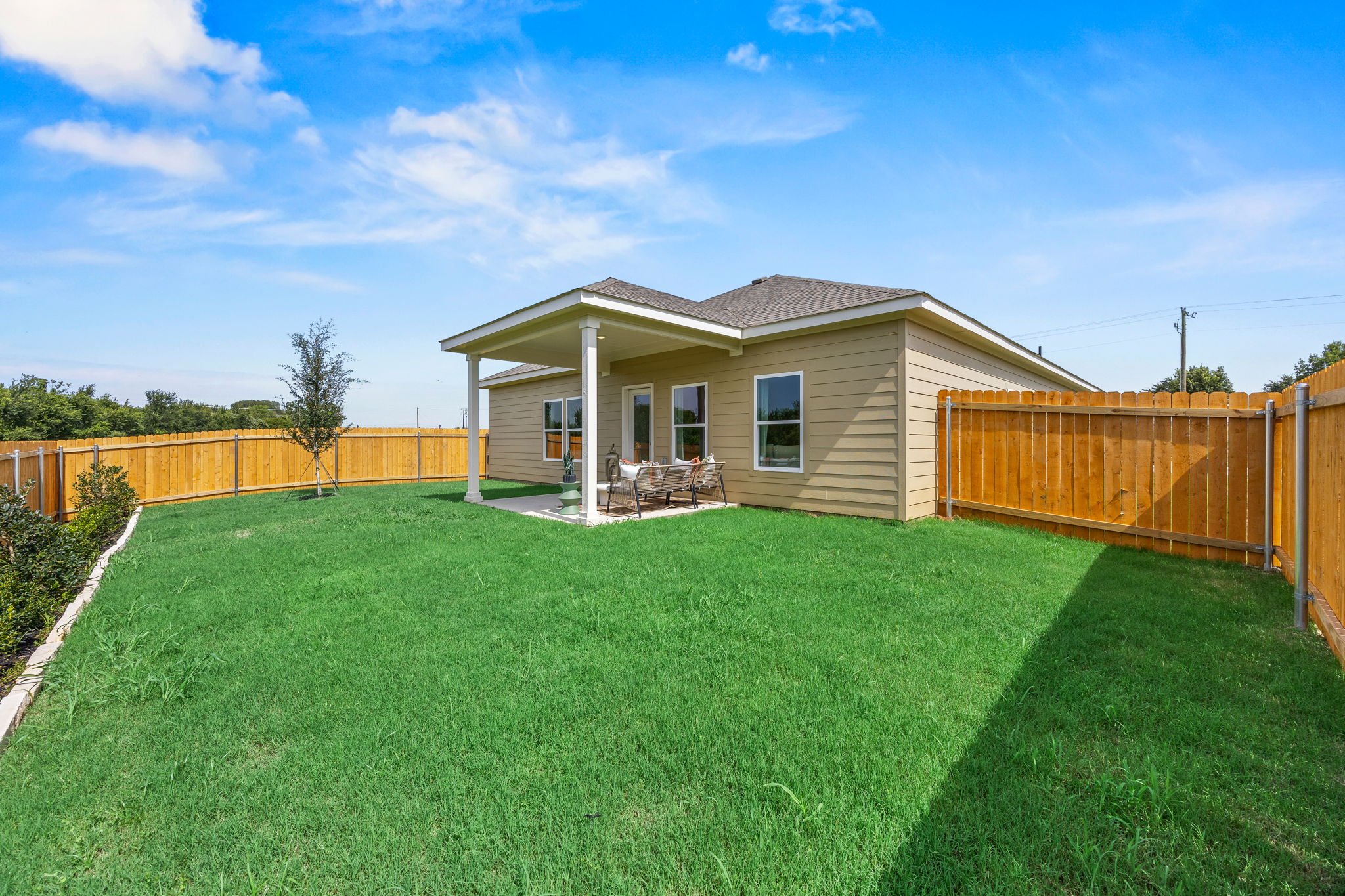 A house with a fence and grass.