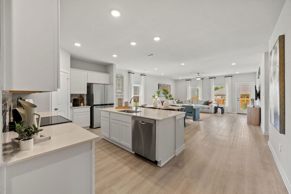 A kitchen with white cabinets.