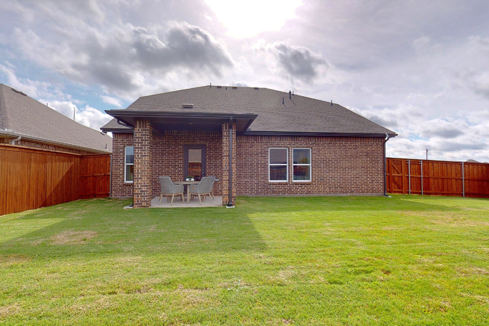 A brick house with a chair in the front.