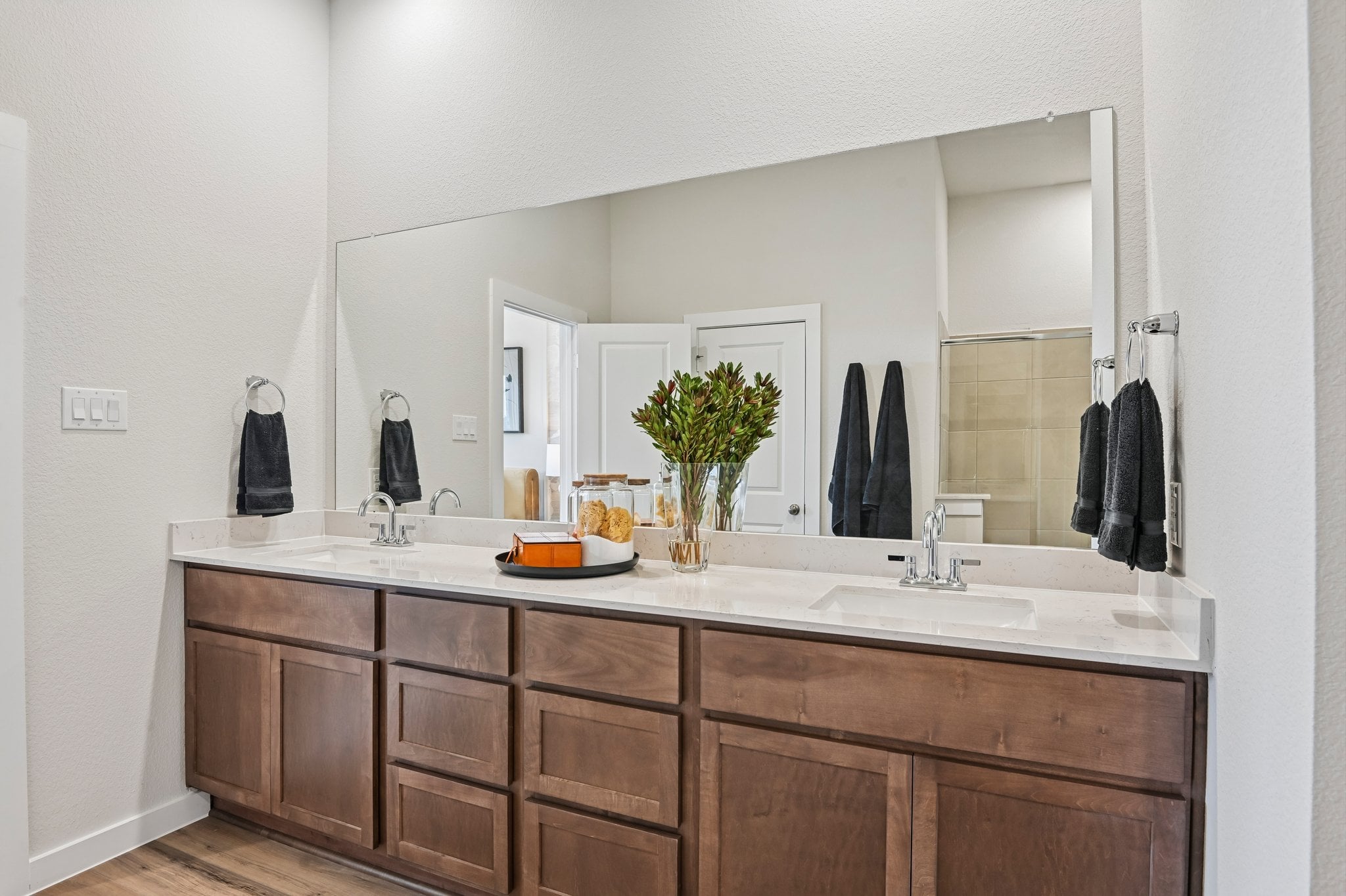 A bathroom with a large mirror.