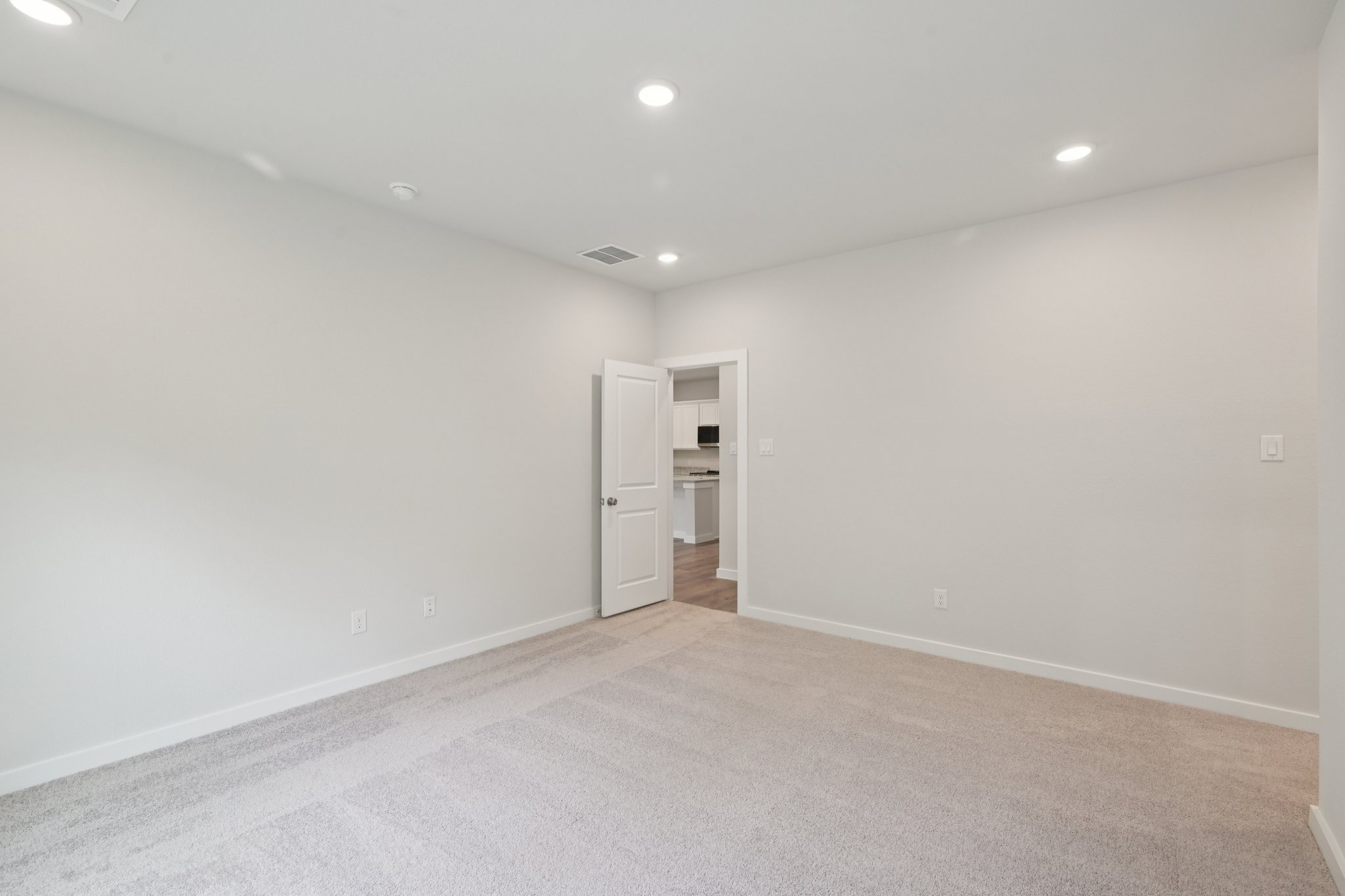 A room with a white wall and a white door.