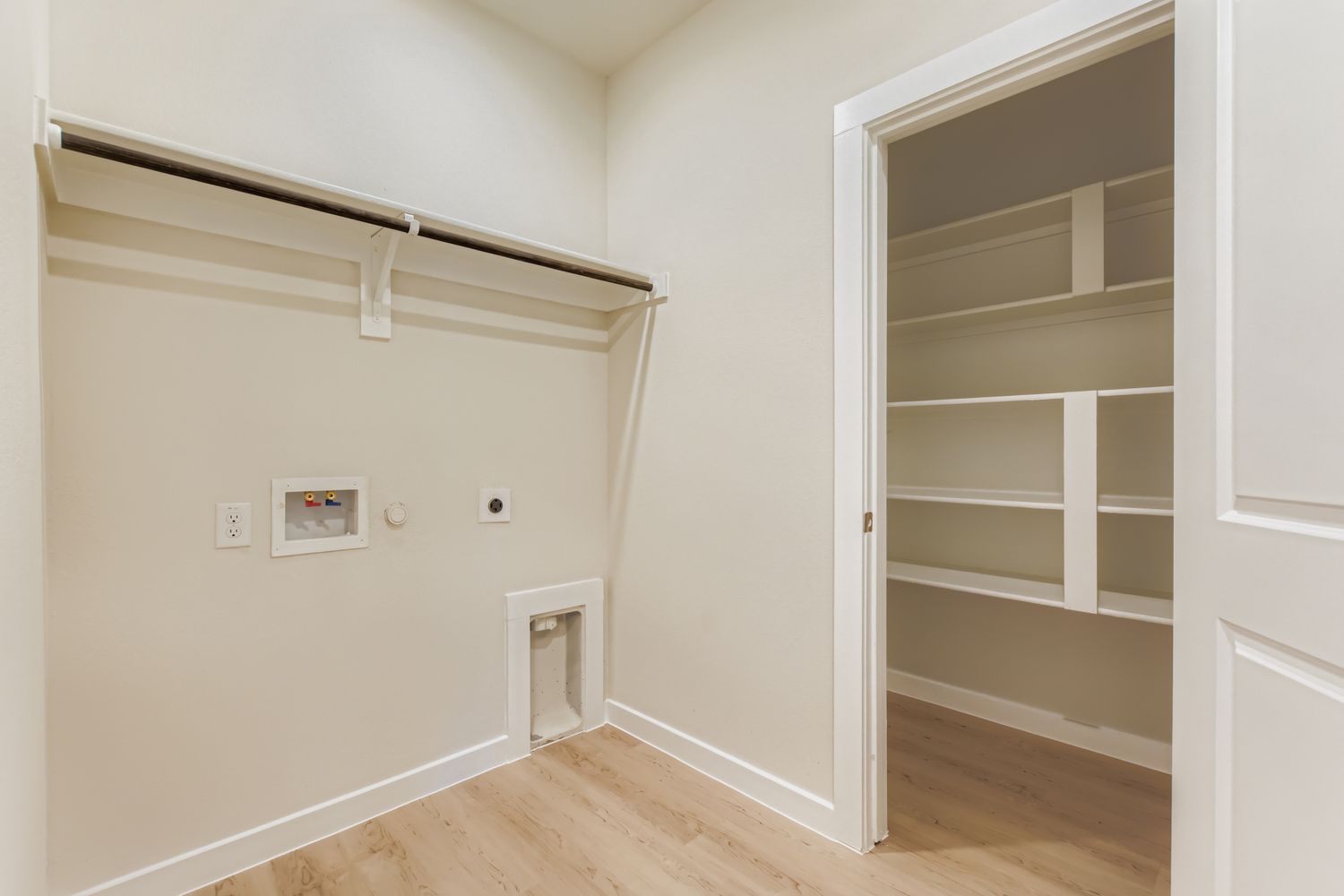 A room with a shelf and a door.
