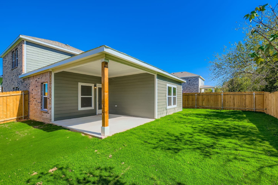 A house with a fence and grass.