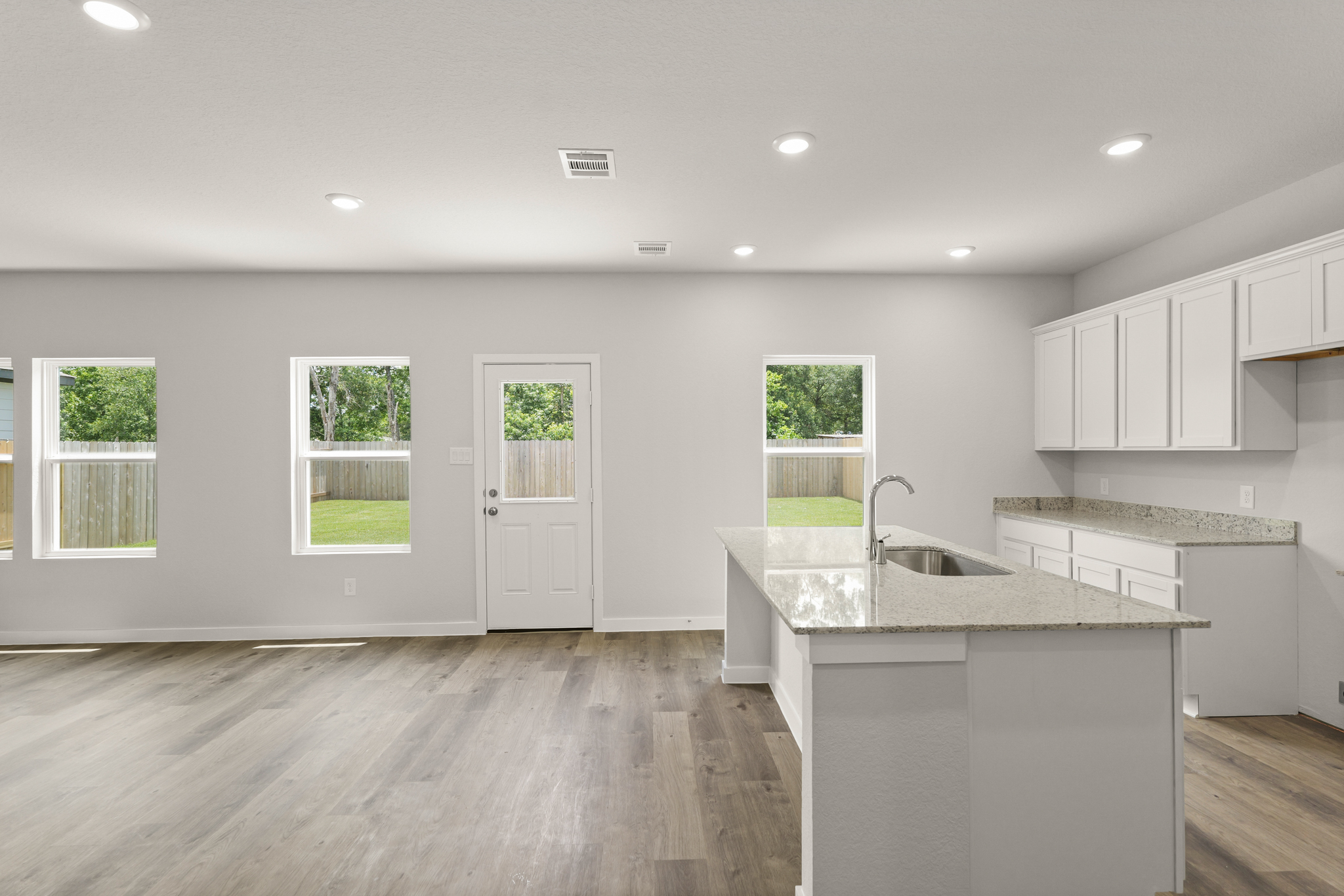 A kitchen with white cabinets.
