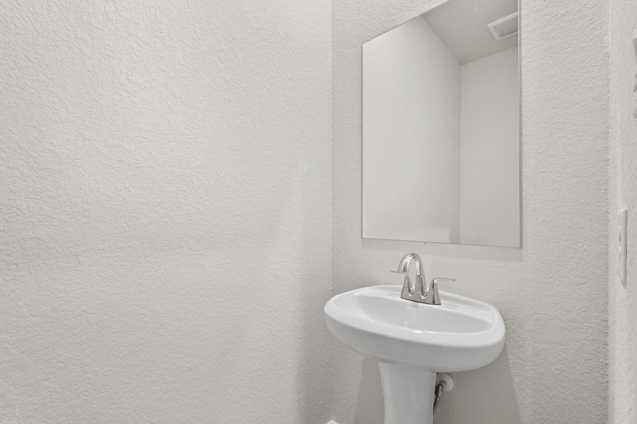 A bathroom with a mirror.