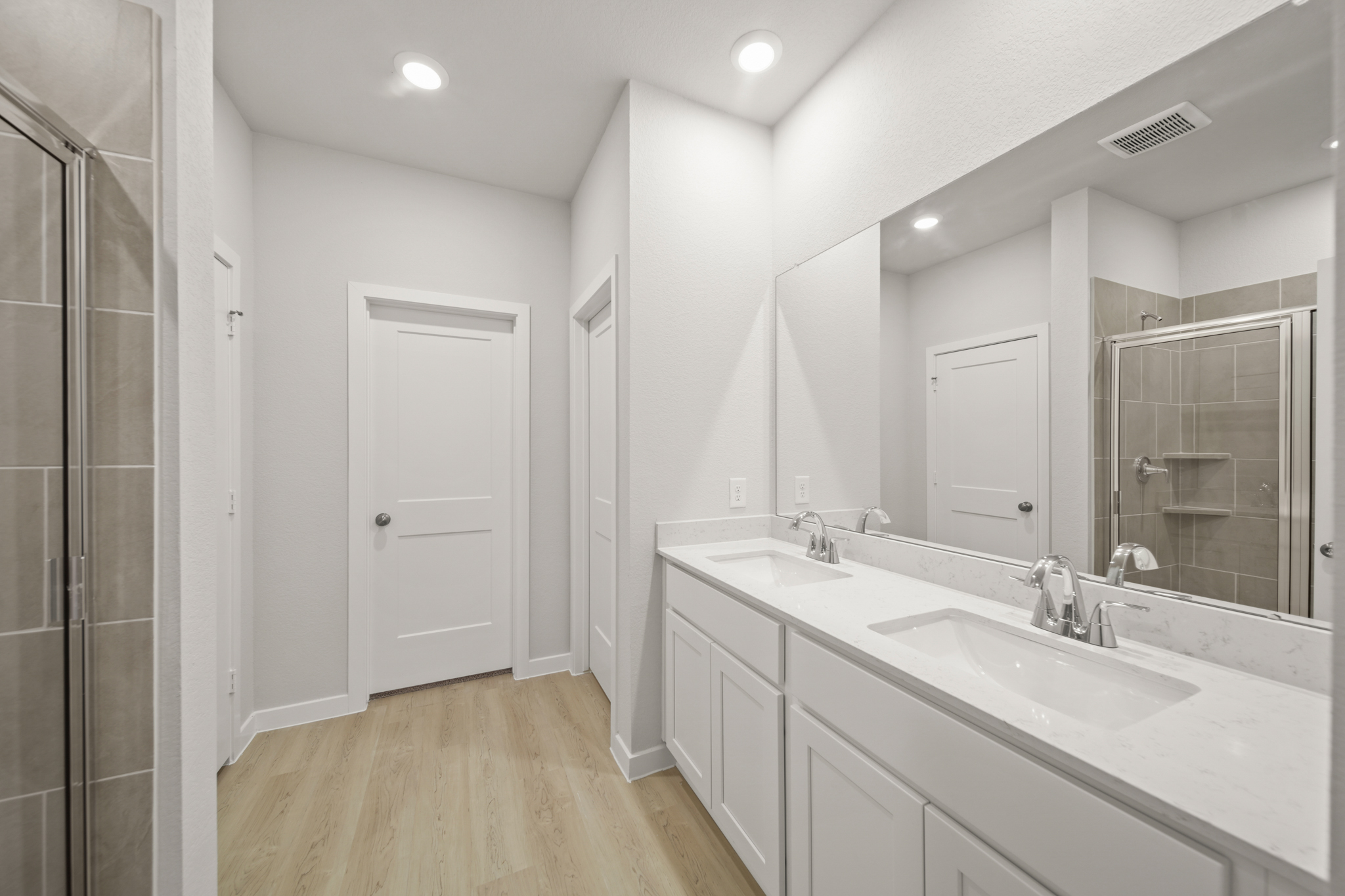 A bathroom with a large mirror.