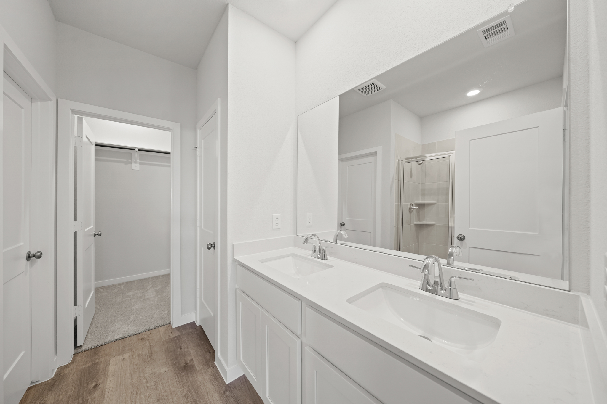 A bathroom with a large mirror.