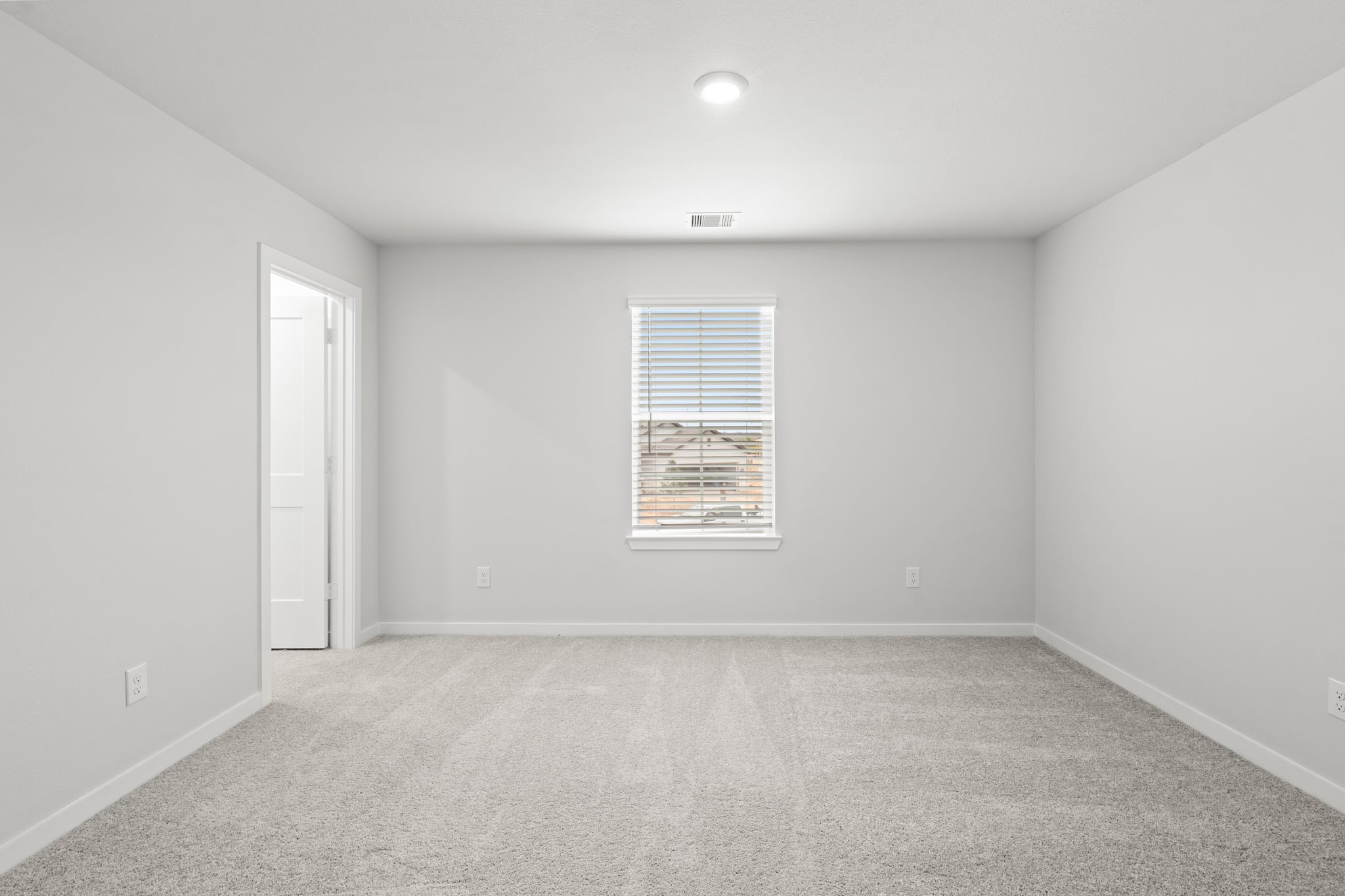 A room with a window and a door.