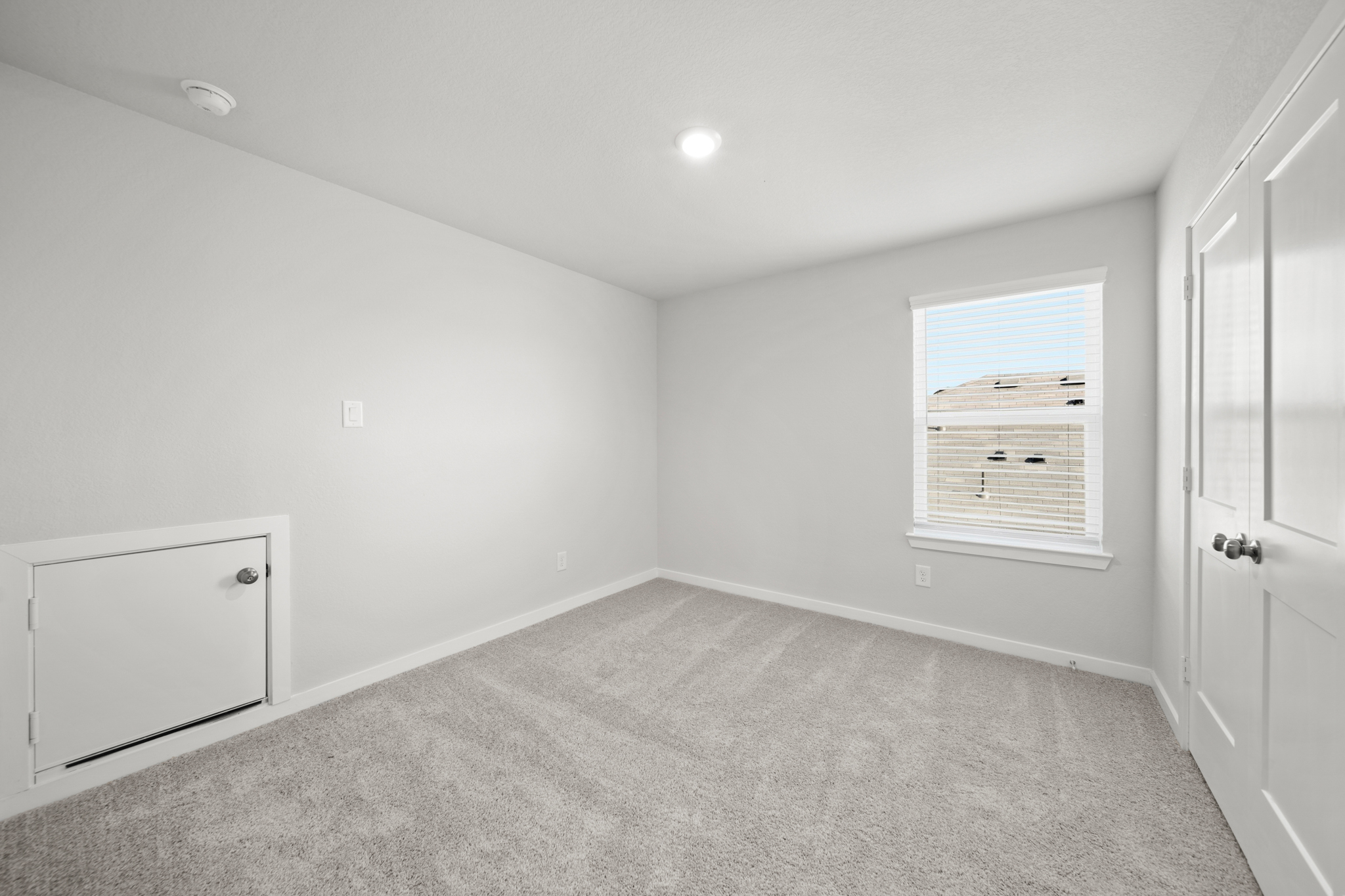 A room with white walls and a white door.