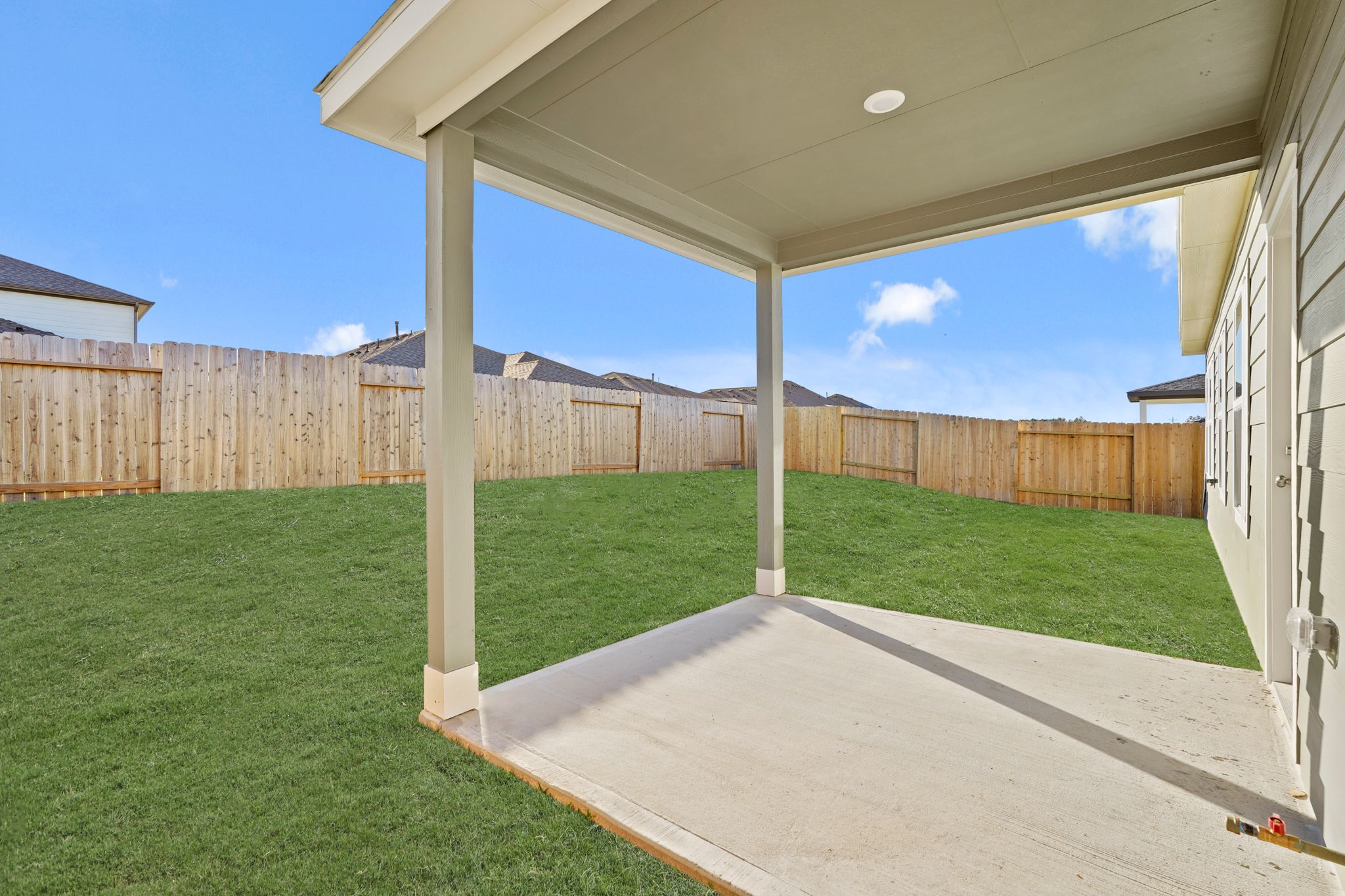 A backyard with a fence.
