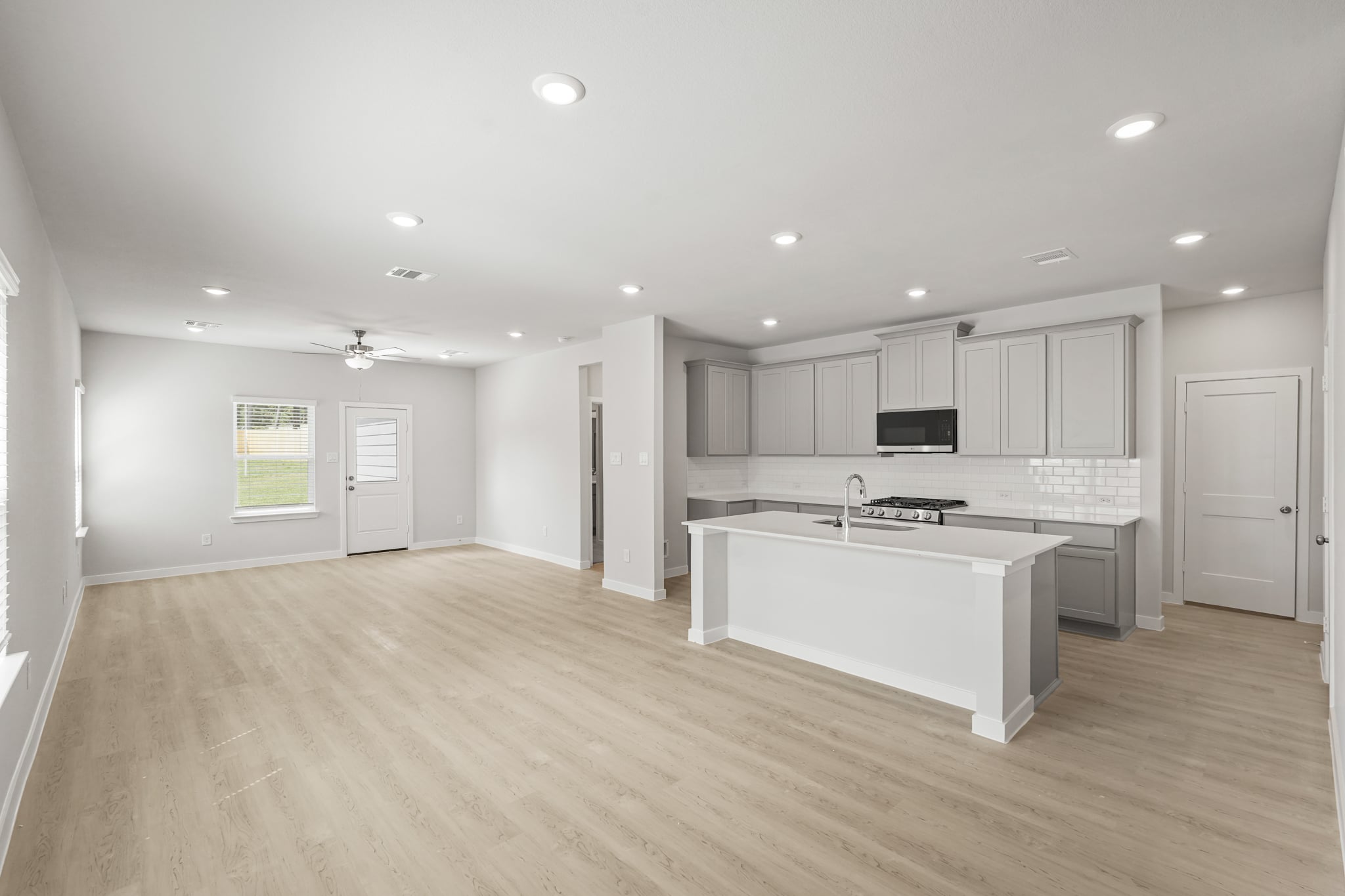 A large kitchen with white cabinets.