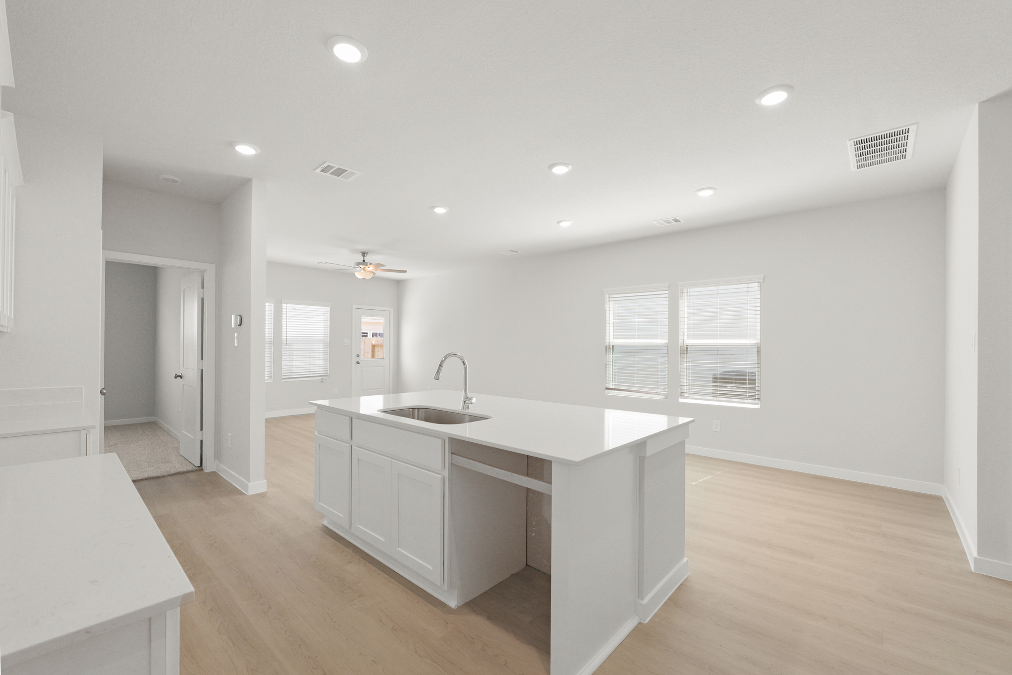 A kitchen with white cabinets.