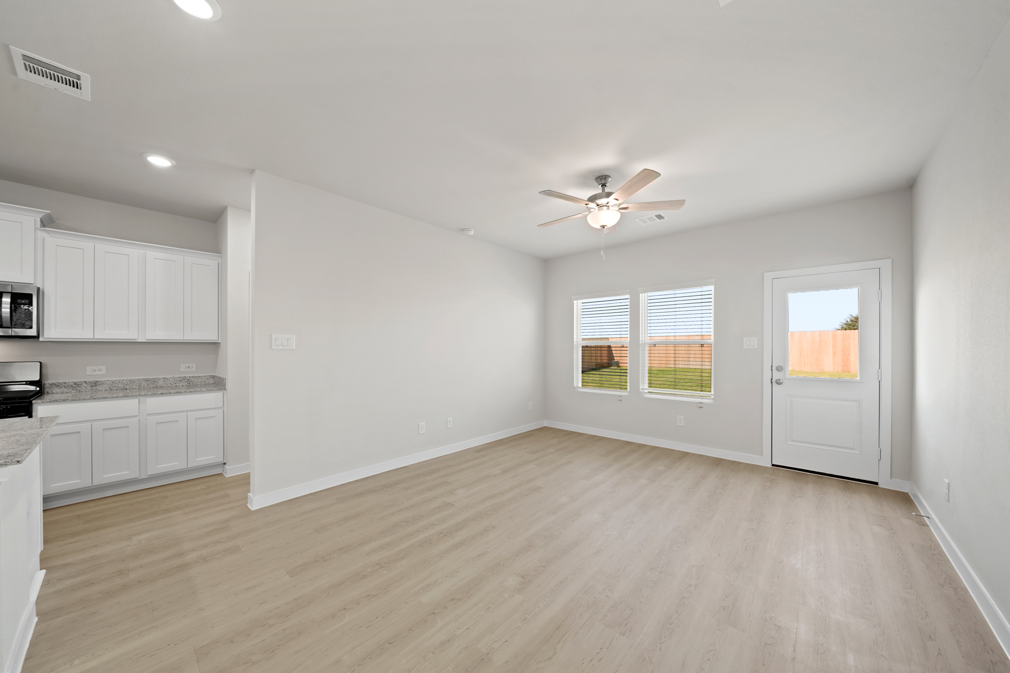 A kitchen with white cabinets.